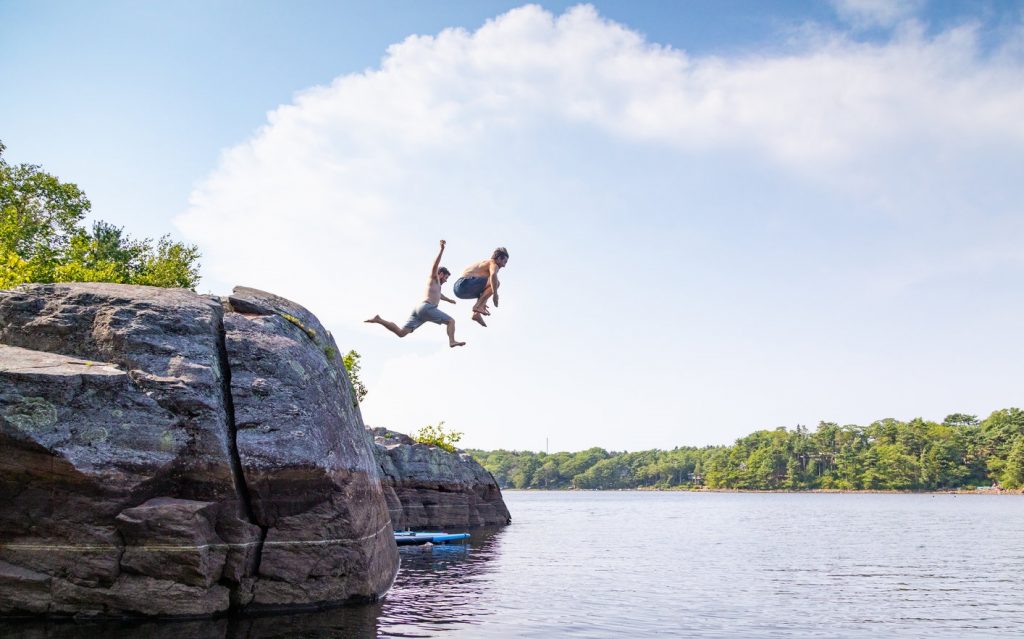 Kids jumping into the lake