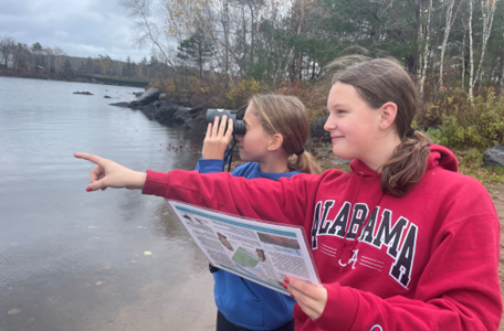 Carly Cogswell and Ava MacKenzie of the Cunard Conservation Crew with ‘Explorer Kit: Birds’ on Cunard Pond, Williams Lake. Photo: Cathy Vaughan
